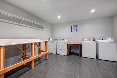 a laundry room with white appliances and a table at Motel 6-Buttonwillow, CA Central in Buttonwillow