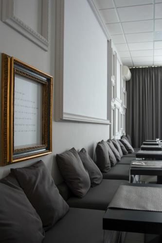 a row of pillows on a couch in a room at Castelmartini Wellness & Business Hotel in Larciano