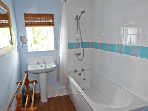 a bathroom with a sink and a bath tub and a sink at Sally End in Ravenstonedale