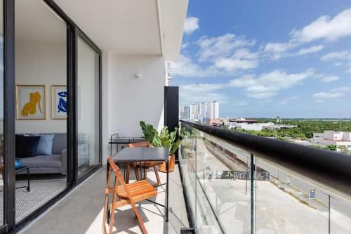 a balcony with a table and chair on a building at San Francisco by Andiani Travel in Cancún