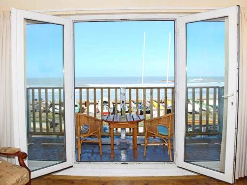 a view of a balcony with a table and chairs at Trysor Y Mor in Borth