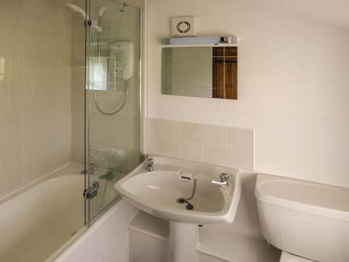 a white bathroom with a sink and a shower at Wenning Bank in Clapham