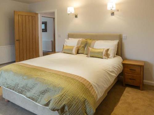 a bedroom with a large white bed with pillows at The Auld Kirk in Forsinain