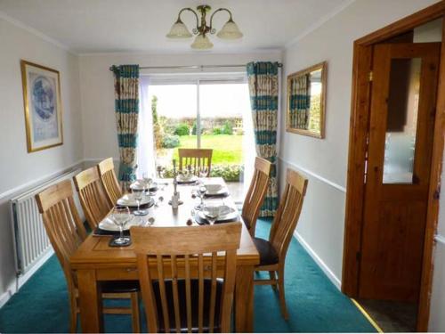 a dining room with a wooden table and chairs at Off Puddle Hill in Stowe