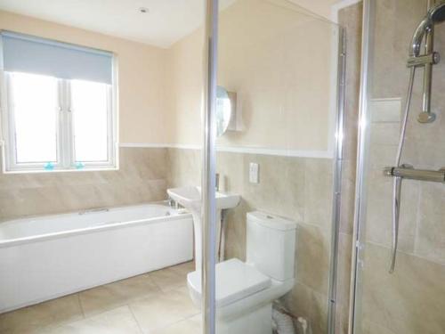 a bathroom with a toilet and a sink and a shower at Pen Hill in Llantwit Major
