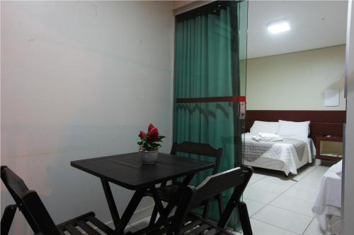a room with a table and chairs and a bed at Amazon Xingu Hotel in Altamira