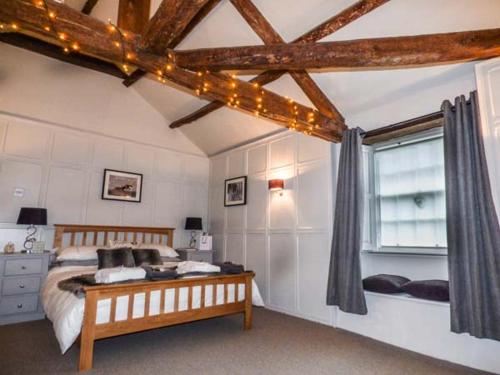 a bedroom with a bed and a window with lights at Castle Hill Cottage in Middleham