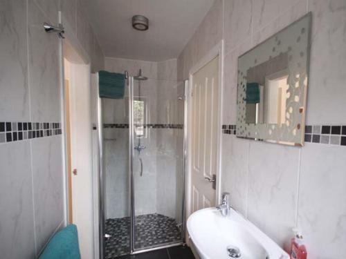 a bathroom with a shower and a sink and a tub at Beechcroft Corner House in Ecclesall