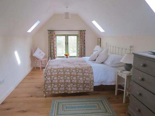 a bedroom with a large bed and a window at Ham's House in Coreley