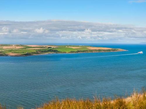 a boat in the middle of a large body of water at Little Laight in Cairnryan