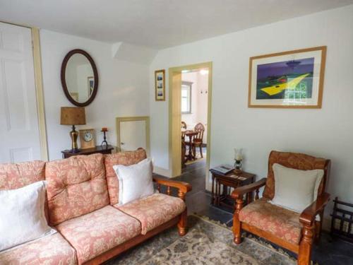 a living room with a couch and two chairs at 3 Glanrafon in Llanwddyn