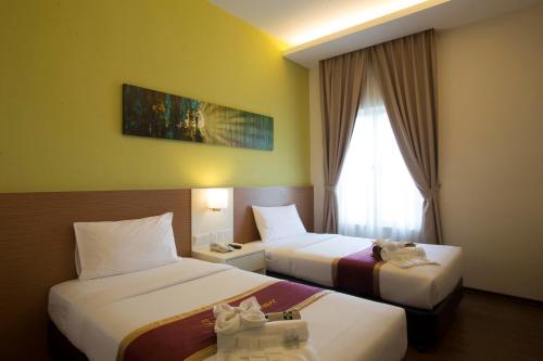 Ένα ή περισσότερα κρεβάτια σε δωμάτιο στο Amansari Hotel Desaru