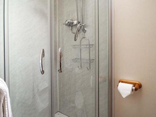 a shower with a glass door in a bathroom at The Old Cider House in Southam