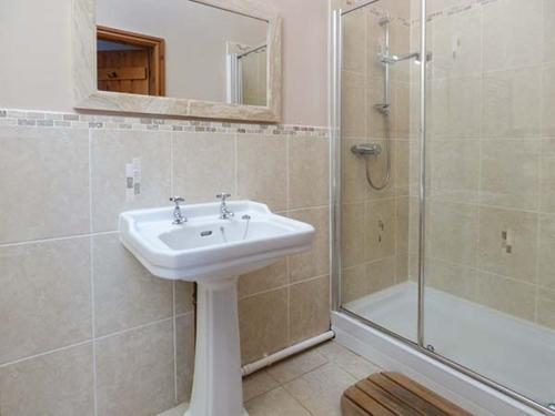 a bathroom with a sink and a shower at Y Wennol in Holyhead