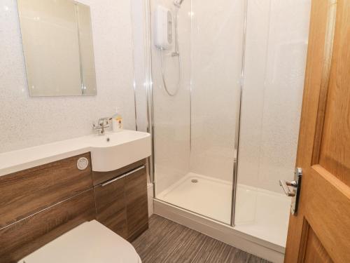 a bathroom with a shower and a sink and a toilet at Station View in Pickering