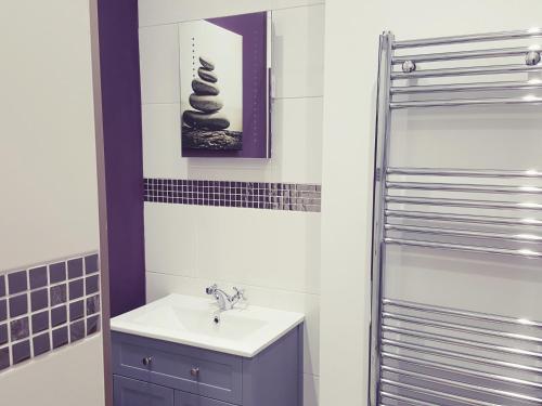 een badkamer met een wastafel en een douche bij Homestead West Wing in Lympsham
