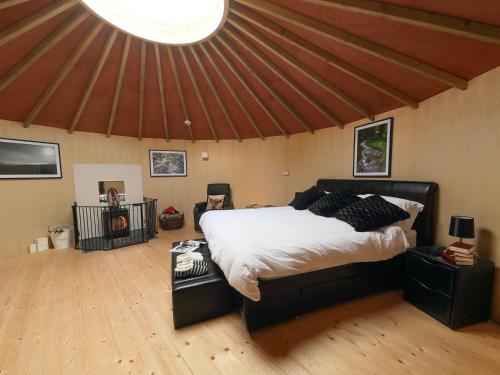 a bedroom with a large bed in a tent at Rolling Hills in Newcastle