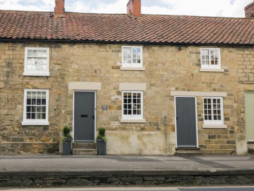 a brick house with two doors and two windows at The Old Cartway in Pickering