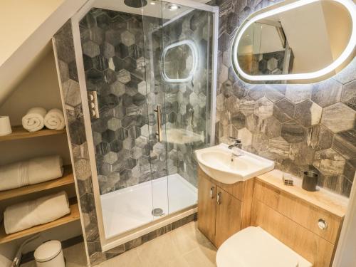a bathroom with a shower and a sink at Lower Tundridge Cottage in Suckley