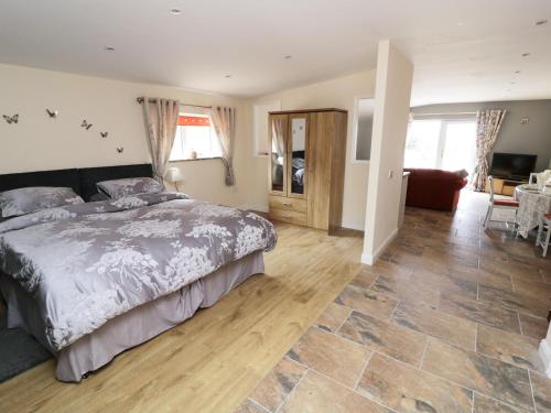 a bedroom with a bed and a living room at Knott Lodge in Milnthorpe