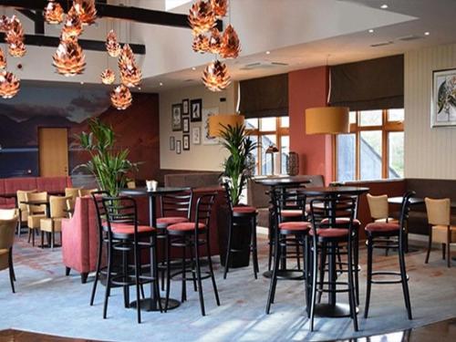 a restaurant with black stools and tables in a room at Whitbarrow Holiday Village Troutbeck 5 in Penruddock