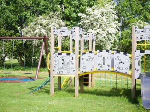 a playground with a slide in a park at Whitbarrow Holiday Village Troutbeck 5 in Penruddock