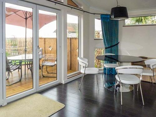 a living room with a table and chairs and a patio at Westview in Weston-super-Mare