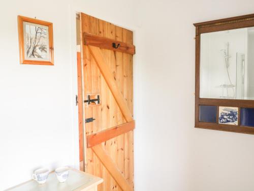 a wooden door in a room with a window at Barn Cottage in West Burton