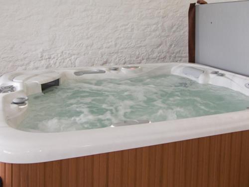 a bath tub filled with water in a bathroom at The Loft in Annan