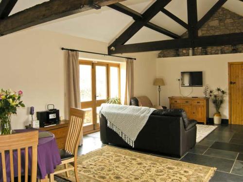 a living room with a couch and a table at The Byre in Abergavenny