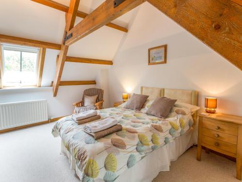 a bedroom with a large bed in a attic at The Bothy in Lowick