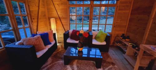 a living room with two couches and a table at EcoChalet Luxury in Ráquira