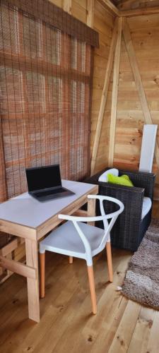 a laptop computer sitting on a table in a cabin at EcoChalet Luxury in Ráquira