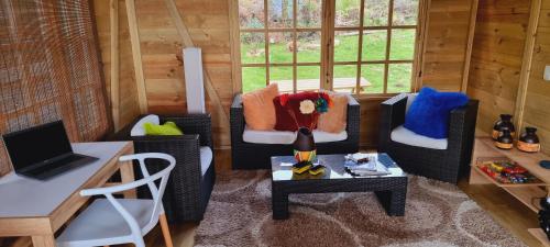 a living room with two chairs and a table at EcoChalet Luxury in Ráquira