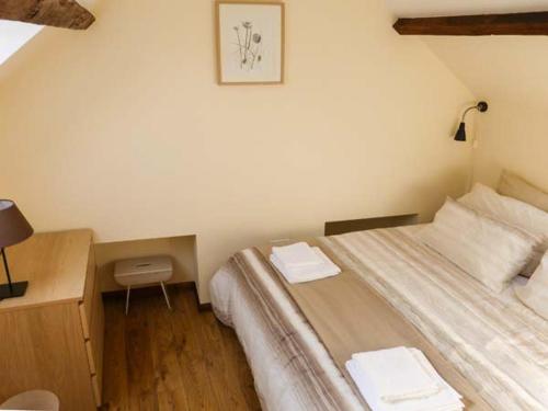 a bedroom with a bed and a desk with a lamp at The Old Stable in Weston-super-Mare