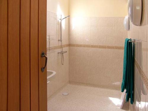 a bathroom with a shower and a bath tub at Byre Cottage in Nesscliffe