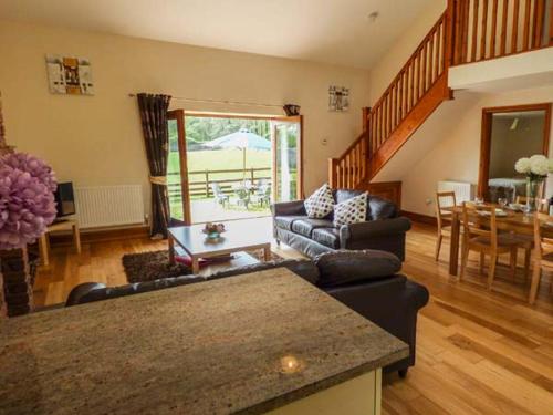 a living room with a couch and a table at Poppy Cottage in Lancaster