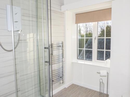 a bathroom with a shower and a window at The Nook in Windermere