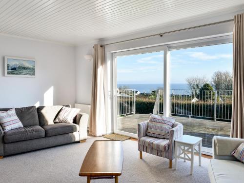 a living room with a view of the ocean at Treverrion in Gorran Haven