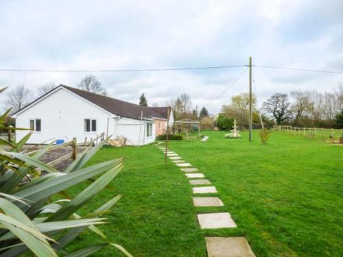 a garden with a path in the grass at The Willows in Ellesmere