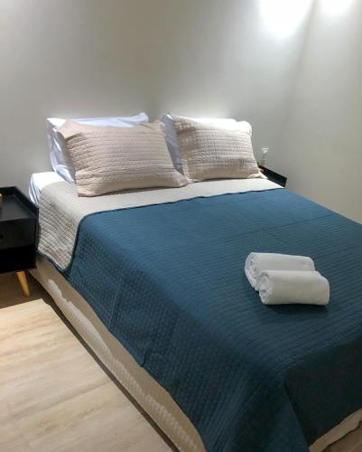 a bed with two towels sitting on top of it at Pousada Sete Mares in Maragogi