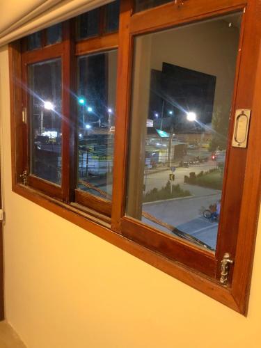 a window with a view of a city at night at Pousada Sete Mares in Maragogi