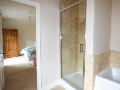 a bathroom with a shower and a sink at East Wing in Crewkerne