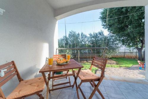 a table with a bowl of fruit on a patio at Apartment Luna in Srima