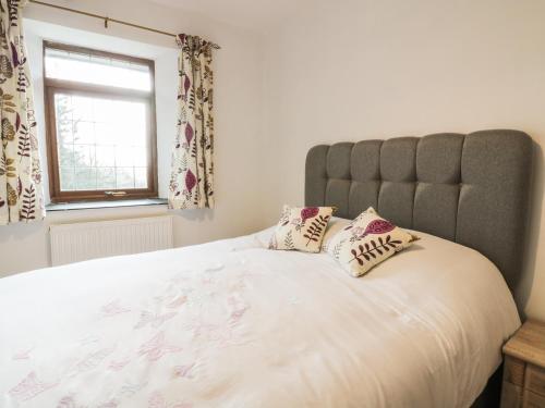 a bedroom with a large bed with pillows on it at Lower West Curry Farmhouse in Launceston