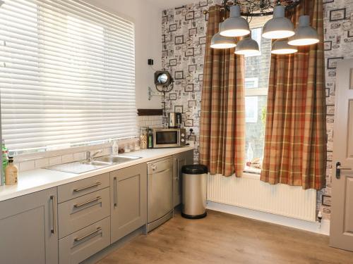 a kitchen with a sink and a window at One Eight Three Guest Cottage in Halifax