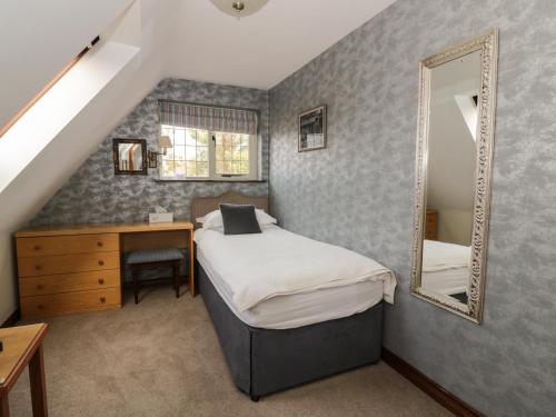 Un pat sau paturi într-o cameră la The Lodge off High Street