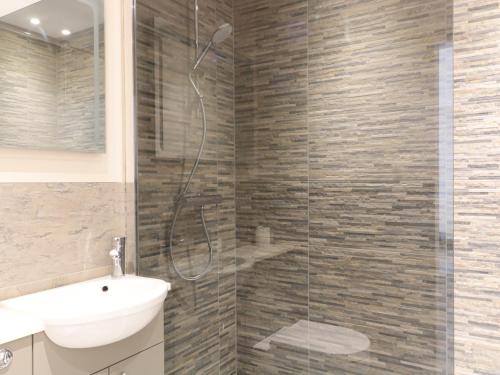 a bathroom with a shower with a toilet and a sink at Wye View in Ross on Wye