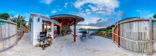 a house with a deck with a view of the water at The Fisherman's Villas in Koh Tao