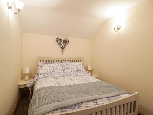 a bedroom with a large bed in a room at The Old Barn in Nether Wasdale